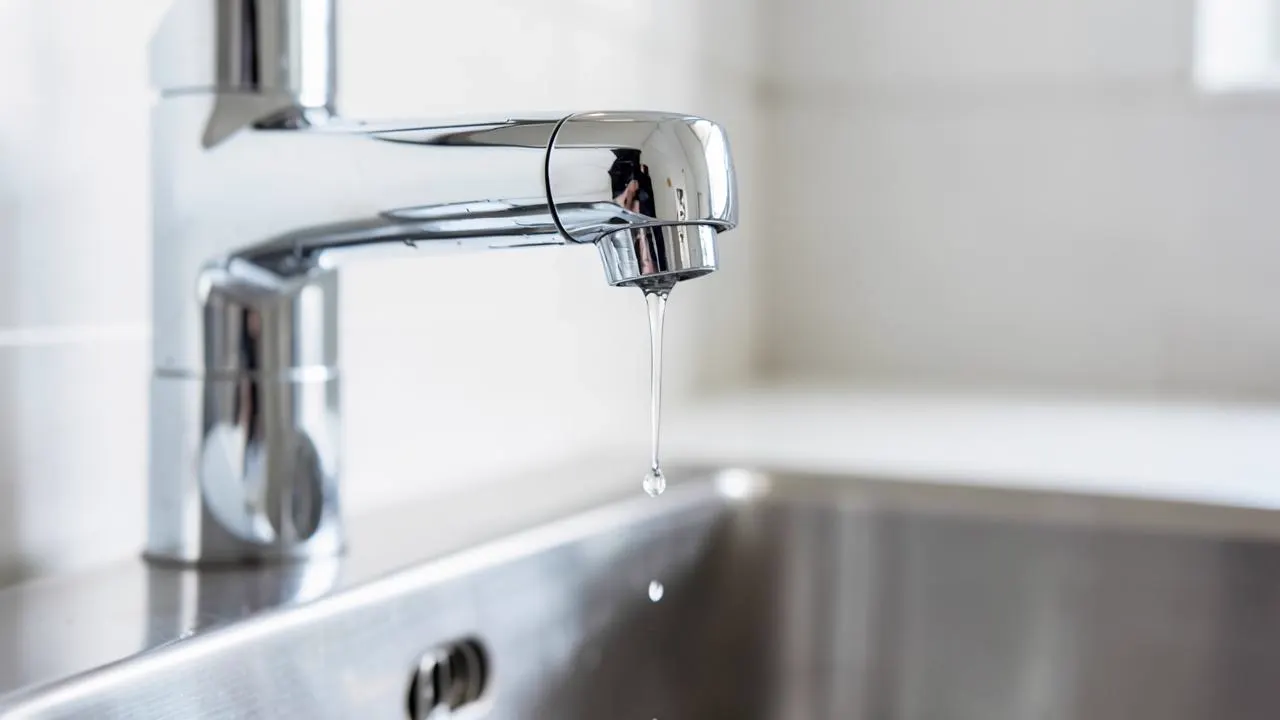 Close-up of a dripping chrome kitchen tap